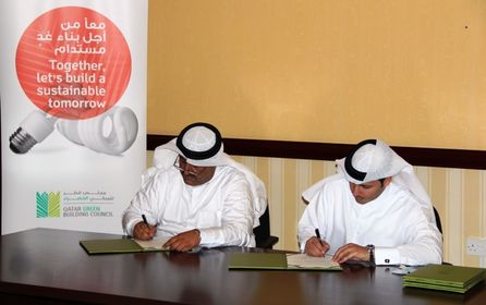 Left to Right - Mr. Ahmad Al Jolo, Chairman of QSE and Engineer Meshal Al Shamari, Director of QGBC, signing the MoU.JPG