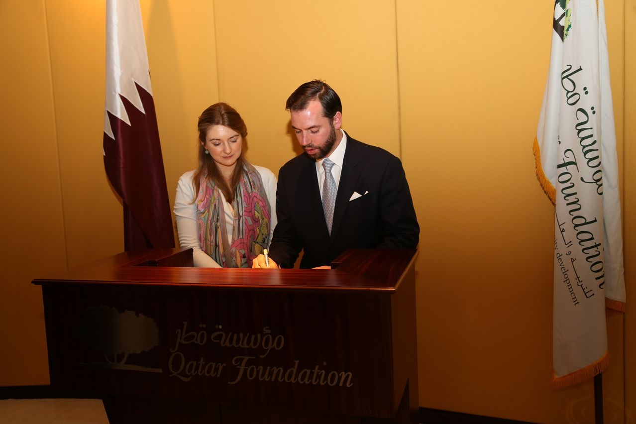 His Royal Highness Crown Prince Guillaume of Luxembourg, standing alongside Her Royal Highness Crown Princess Stéphanie of Luxembourg, signing the Qatar Foundation Visitor’s Book.